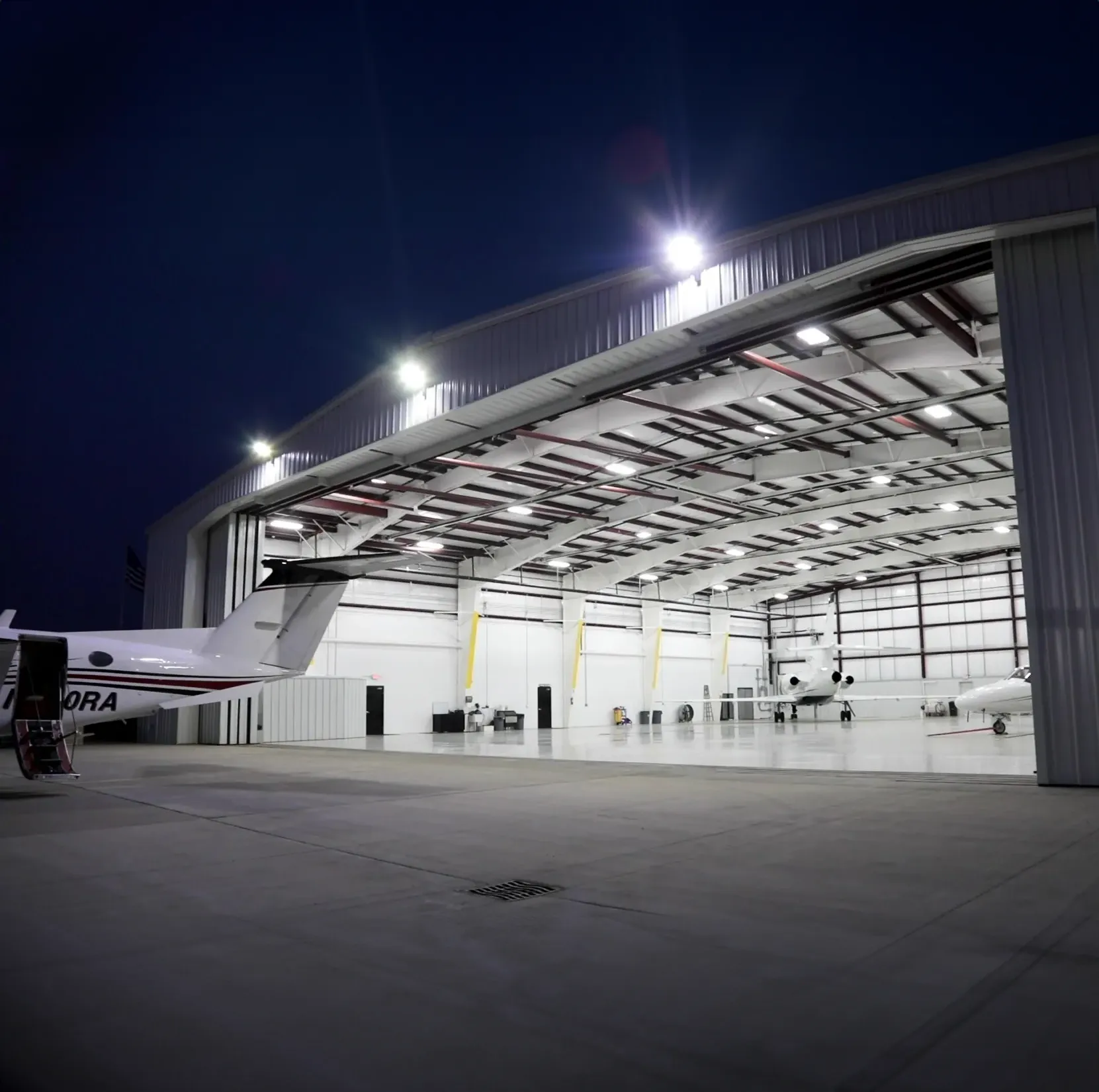 Red building with canopy over picnic tables