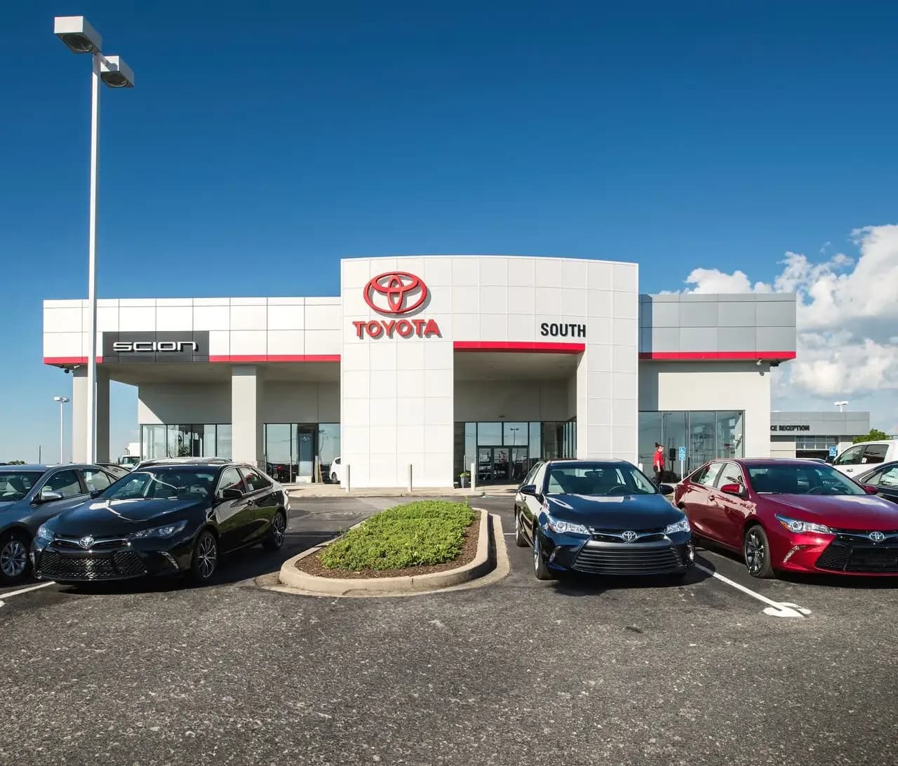 Red building with canopy over picnic tables